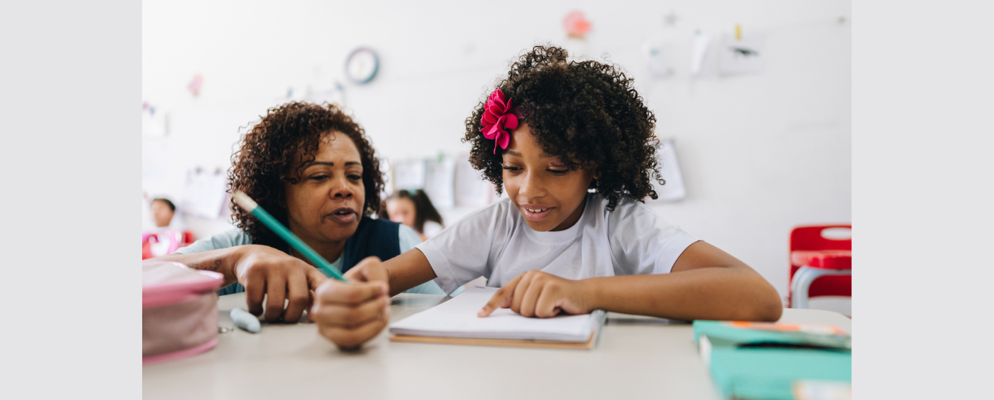 Teacher working with student